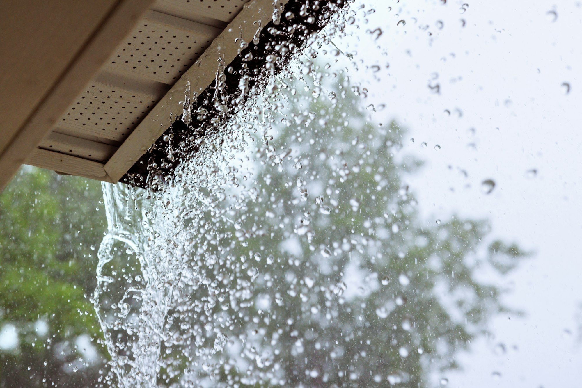During a downpour, water escapes from the over gutters.