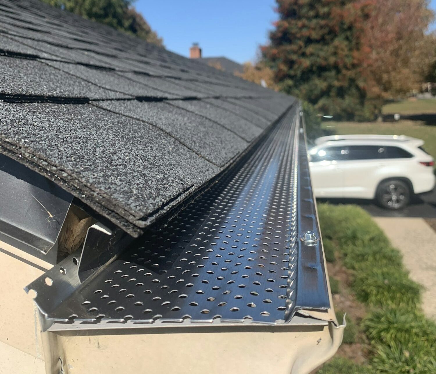 Roof of a house showing gutter and gutter guard protection against leaves