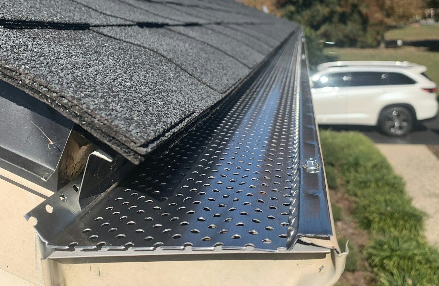 Roof of a house showing gutter and gutter guard protection against leaves